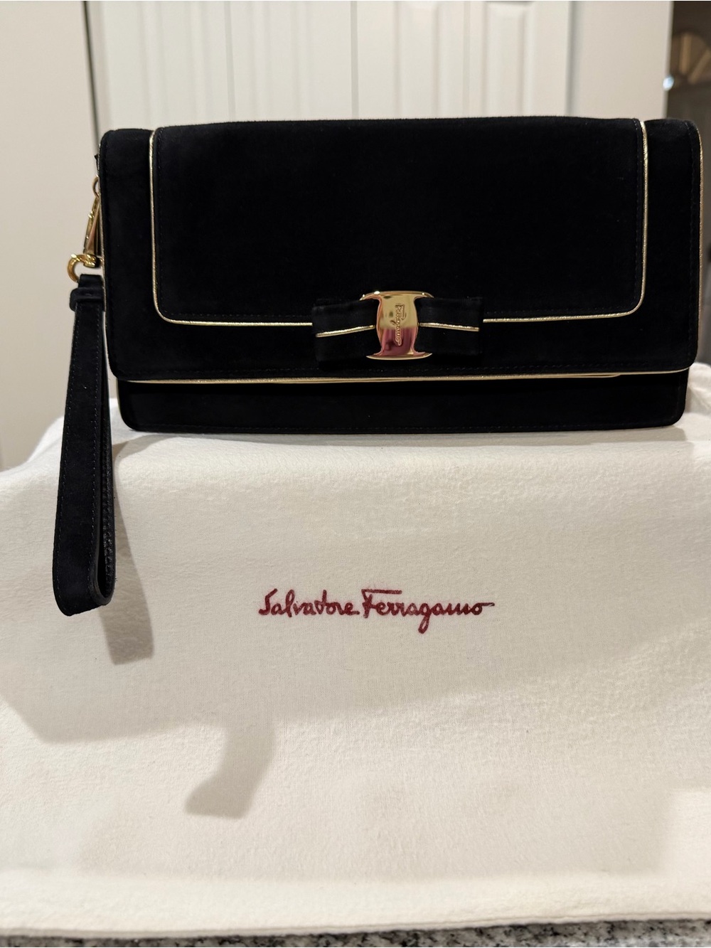 SALVATORE FERRAGAMO BLACK SUEDE WRISTLET CLUTCH WITH GOLD TRIM